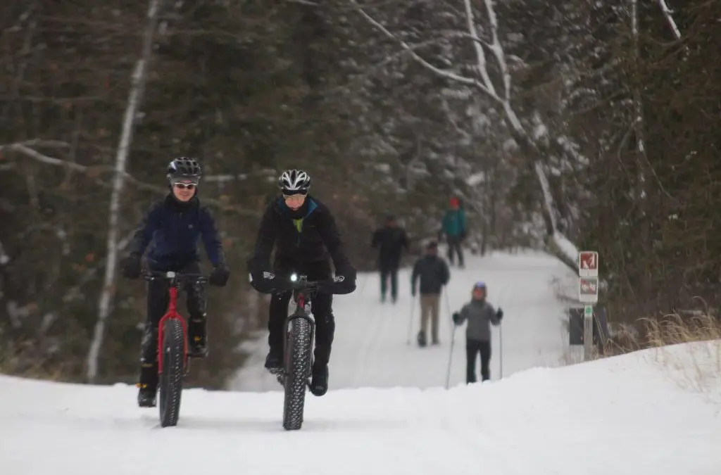 Image showing mountrain biikers and cross country skiers in the snow. Glen Arbor, Michigan winter activites